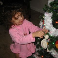 Ana Puts on an Ornament.JPG