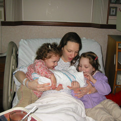 Helping Hold Sister.jpg